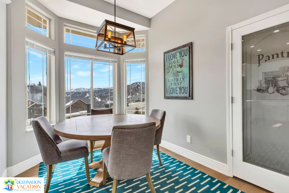 Sunlit dining nook overlooking peaceful mountain scenery.