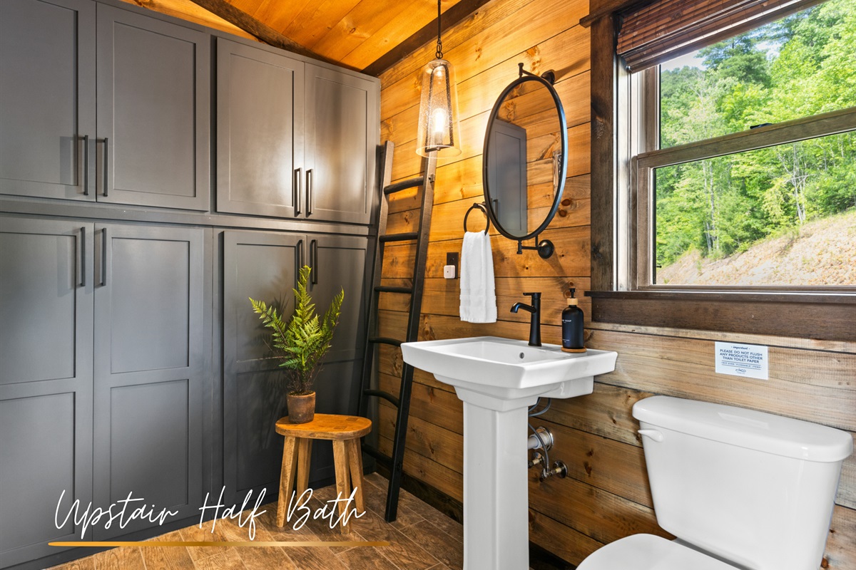 Upstairs private half-bath with a touch of poetry.
