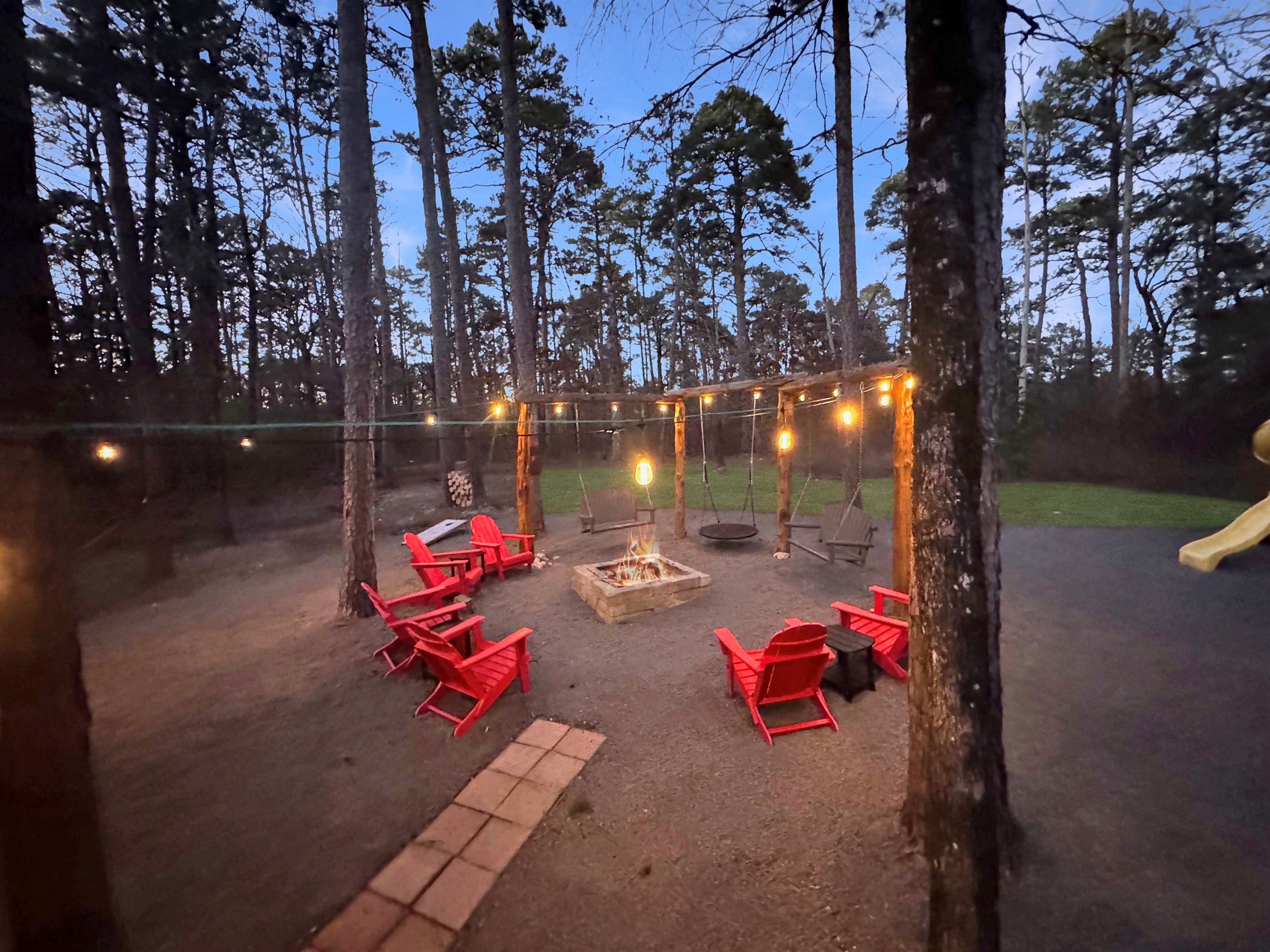 Twinkling lights, crackling fire, bubbling hot tub - pure backyard bliss.