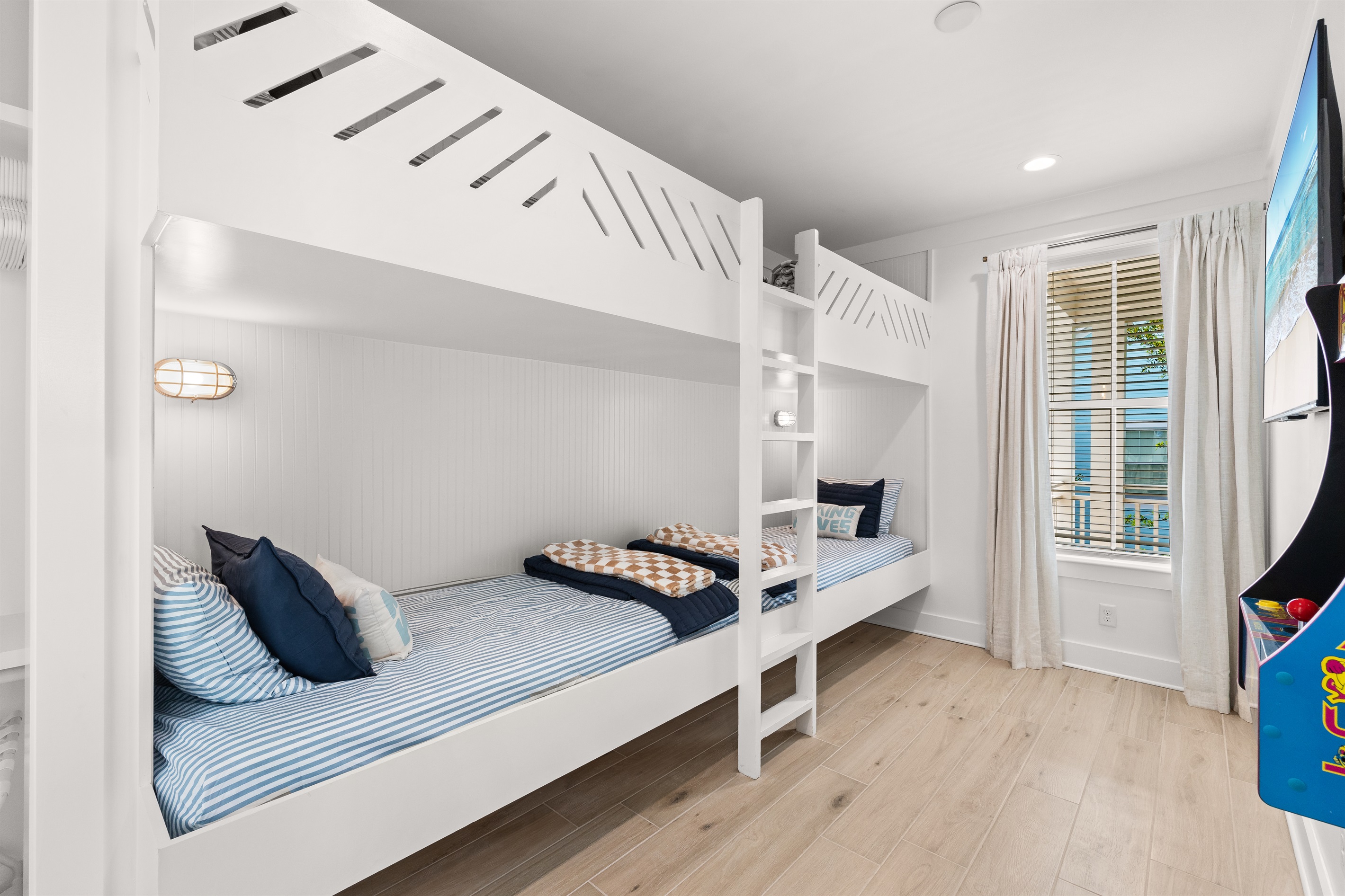 Thoughtfully designed for larger groups, this bright and welcoming bunk room provides plenty of sleeping space while maintaining a relaxed beach-house feel.
