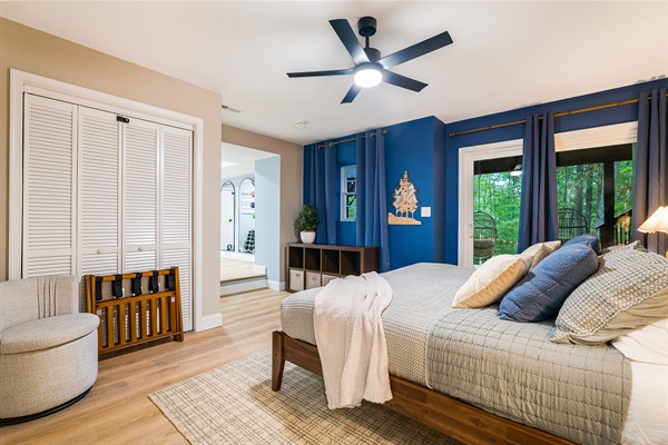Wake up to forest views in this spacious bedroom with walkout deck access. A peaceful retreat for early risers who love morning coffee outdoors or anyone craving quiet moments away from the main gathering spaces.