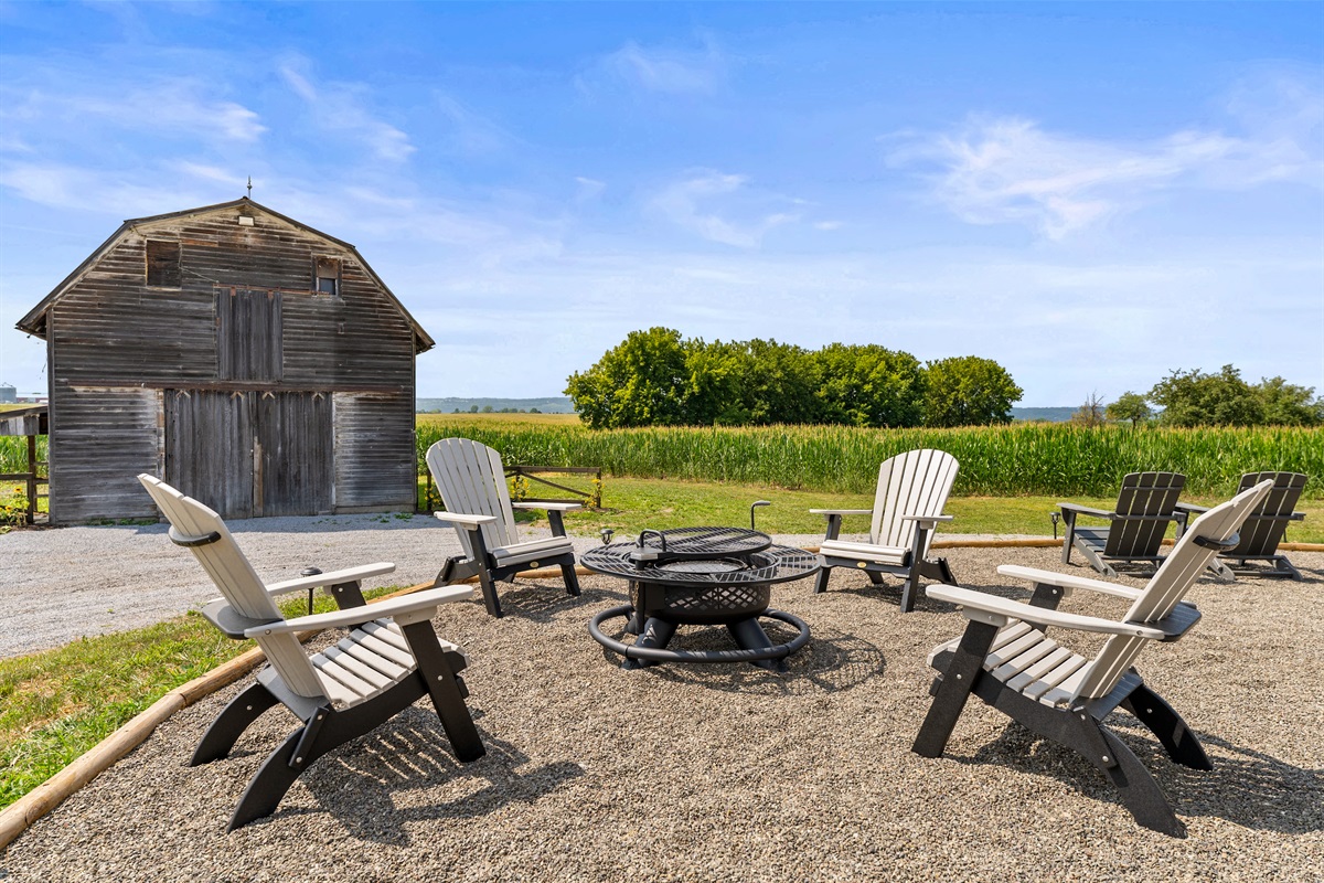 Gather around the fire pit with friends, surrounded by wide-open farmland and a classic barn backdrop.