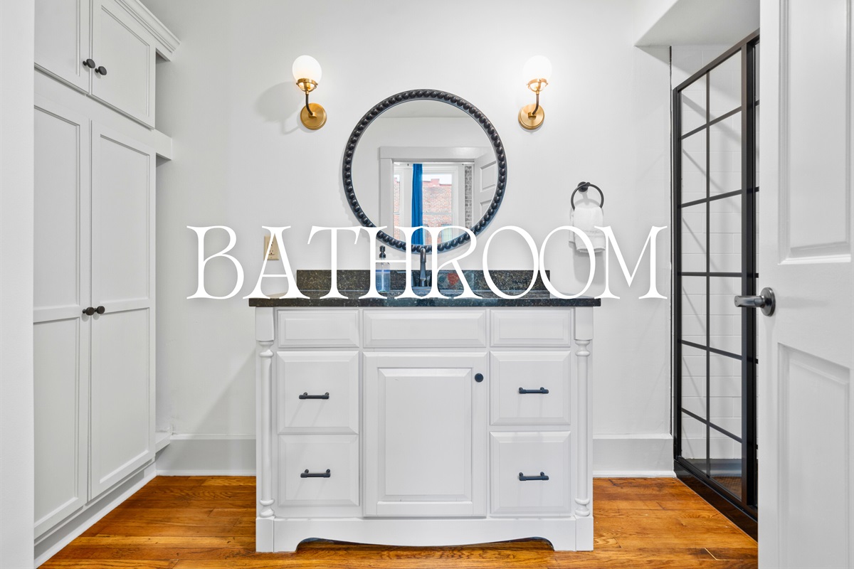 A thoughtfully designed bathroom with a sleek vanity and a walk-in shower offers a clean and comfortable space to refresh.
