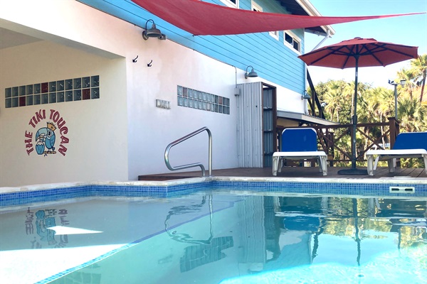 Splashing in the sun, pool with outdoor seating and shade 