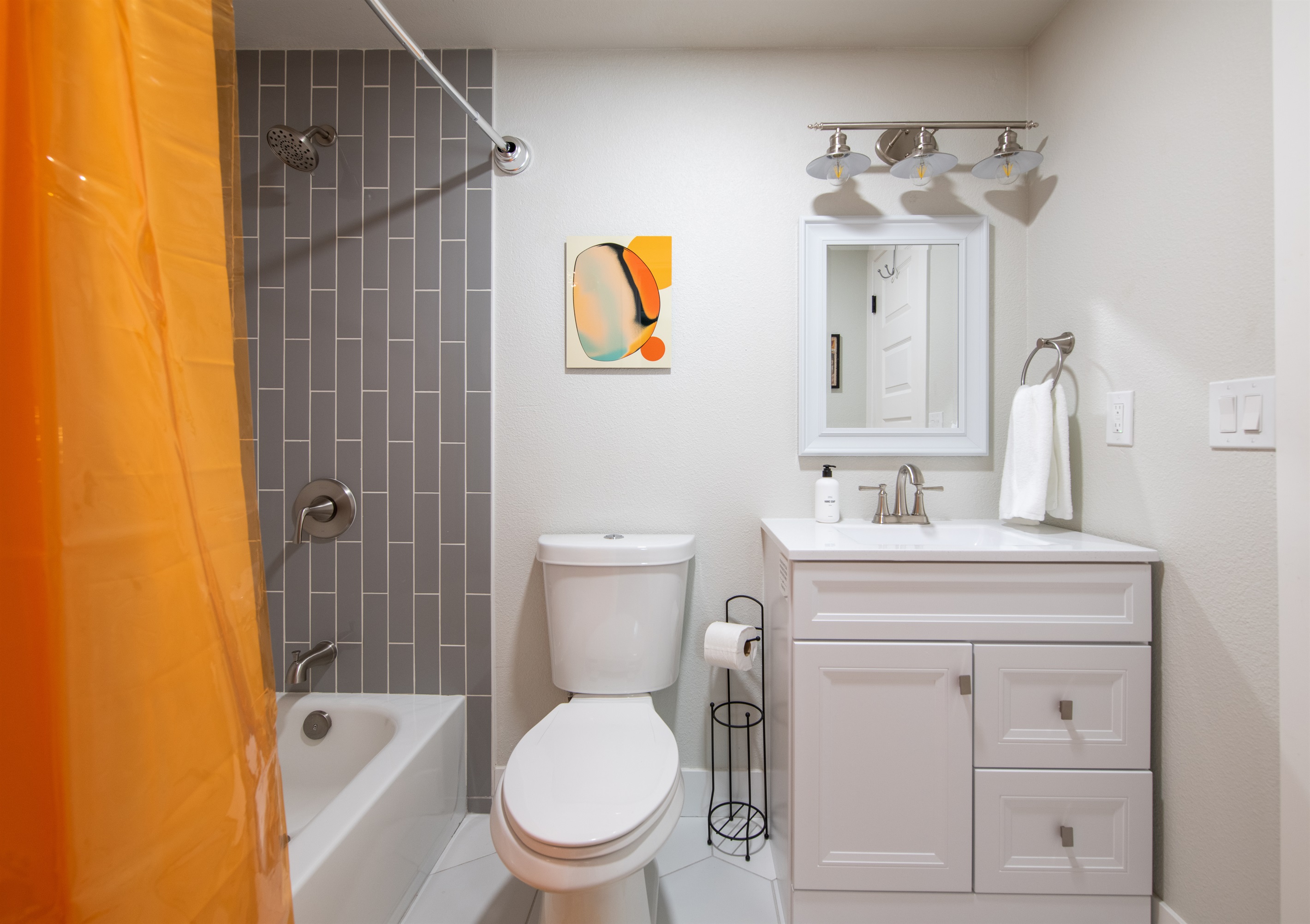 Full size bathroom with shower/bathtub next to dining room table area