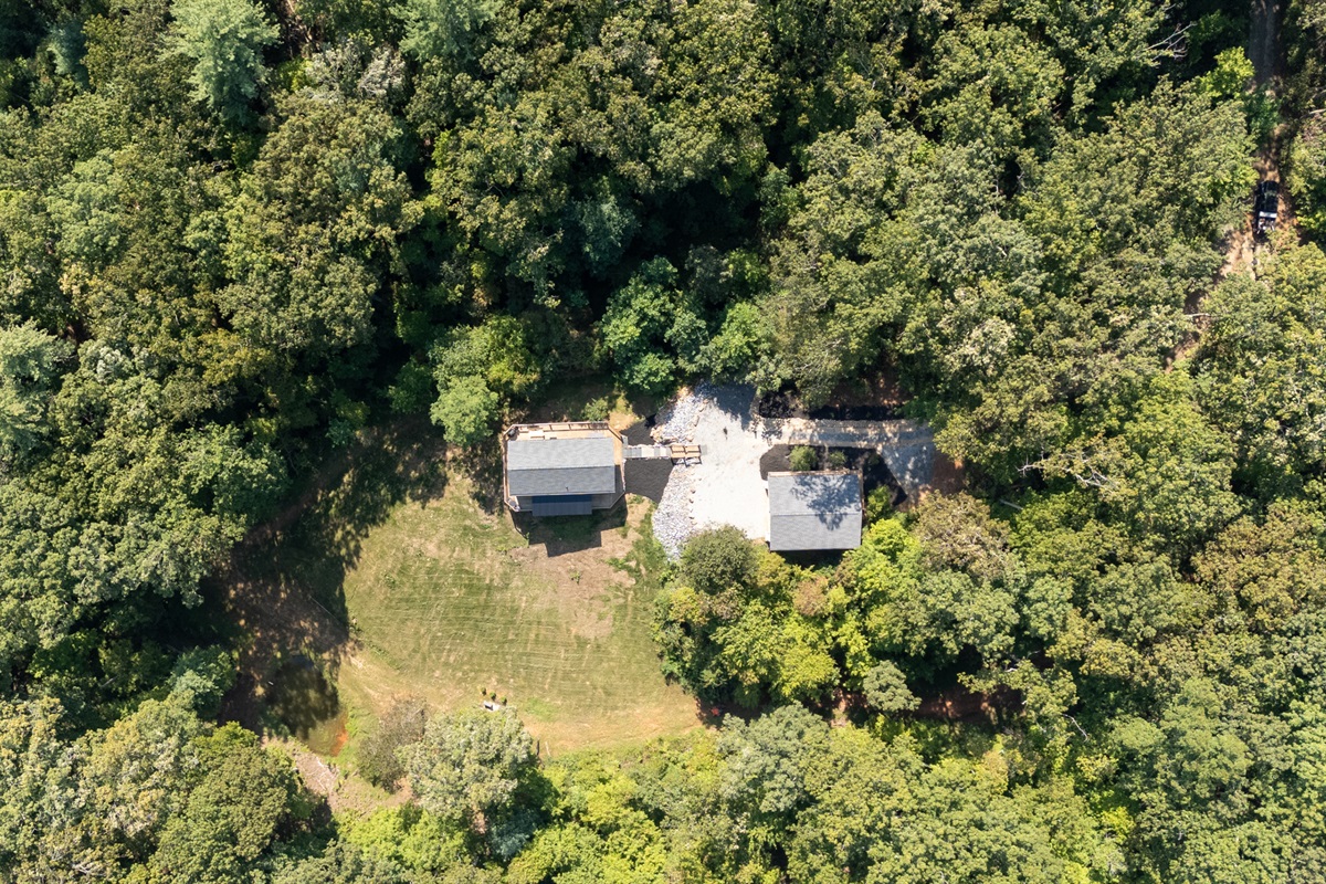 Wide drone shot highlighting Heart Ridge’s peaceful valley setting on 8 private acres.