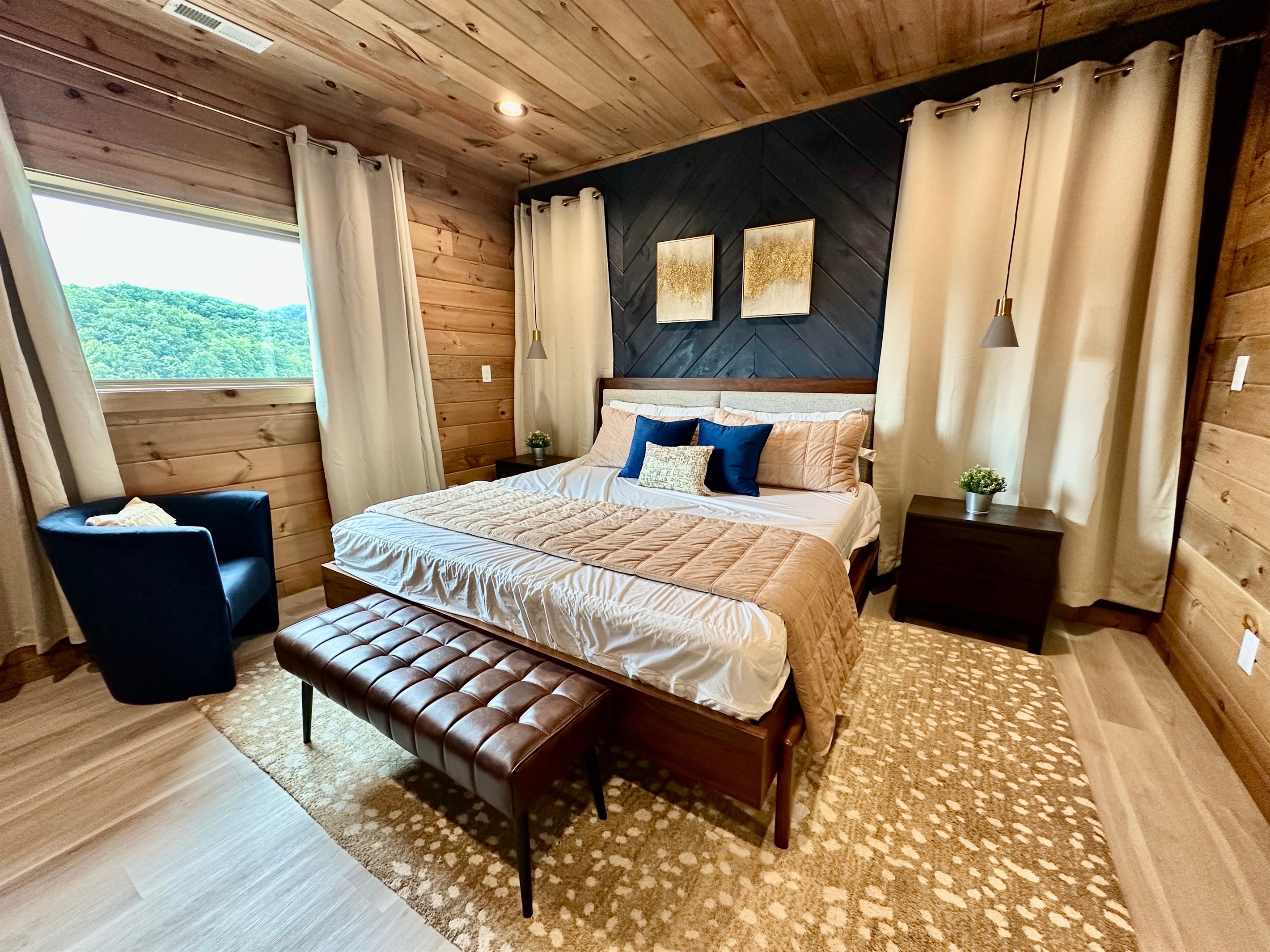 A serene king suite designed for true rest. Warm wood tones, plush layers, and soft natural light create a calming retreat, perfect for slow mornings and peaceful mountain nights.