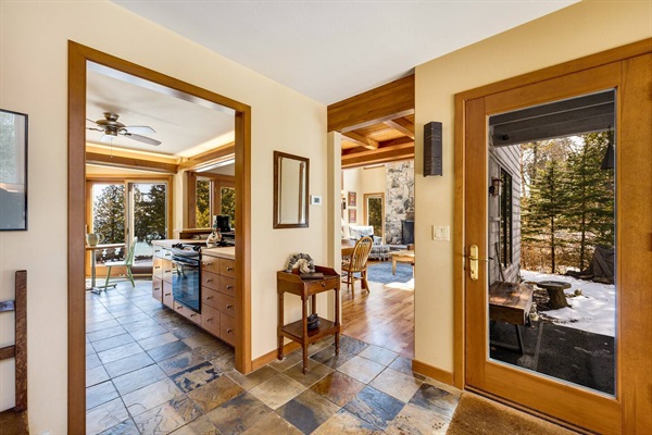 The foyer greets you with a slate floor and wood all around.
