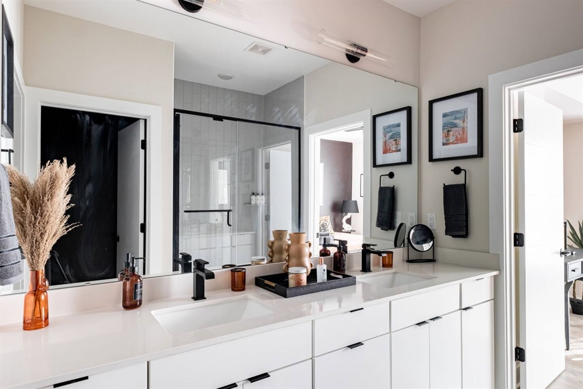 This 3rd floor ensuite (just off a king bedroom) has double vanities, a walk in shower, door to the commode, and a walk in closet (not visible in this photo). 