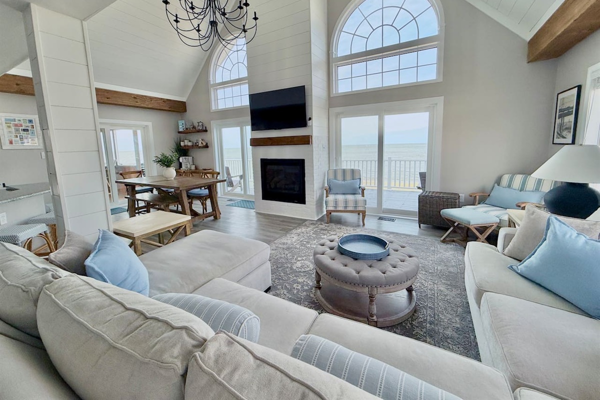 Enjoy the ultimate luxury in this expansive, light-filled living area. With soaring ceilings, a warm fireplace, and breathtaking ocean views, it provides a serene, elegant space perfect for gathering and relaxing.