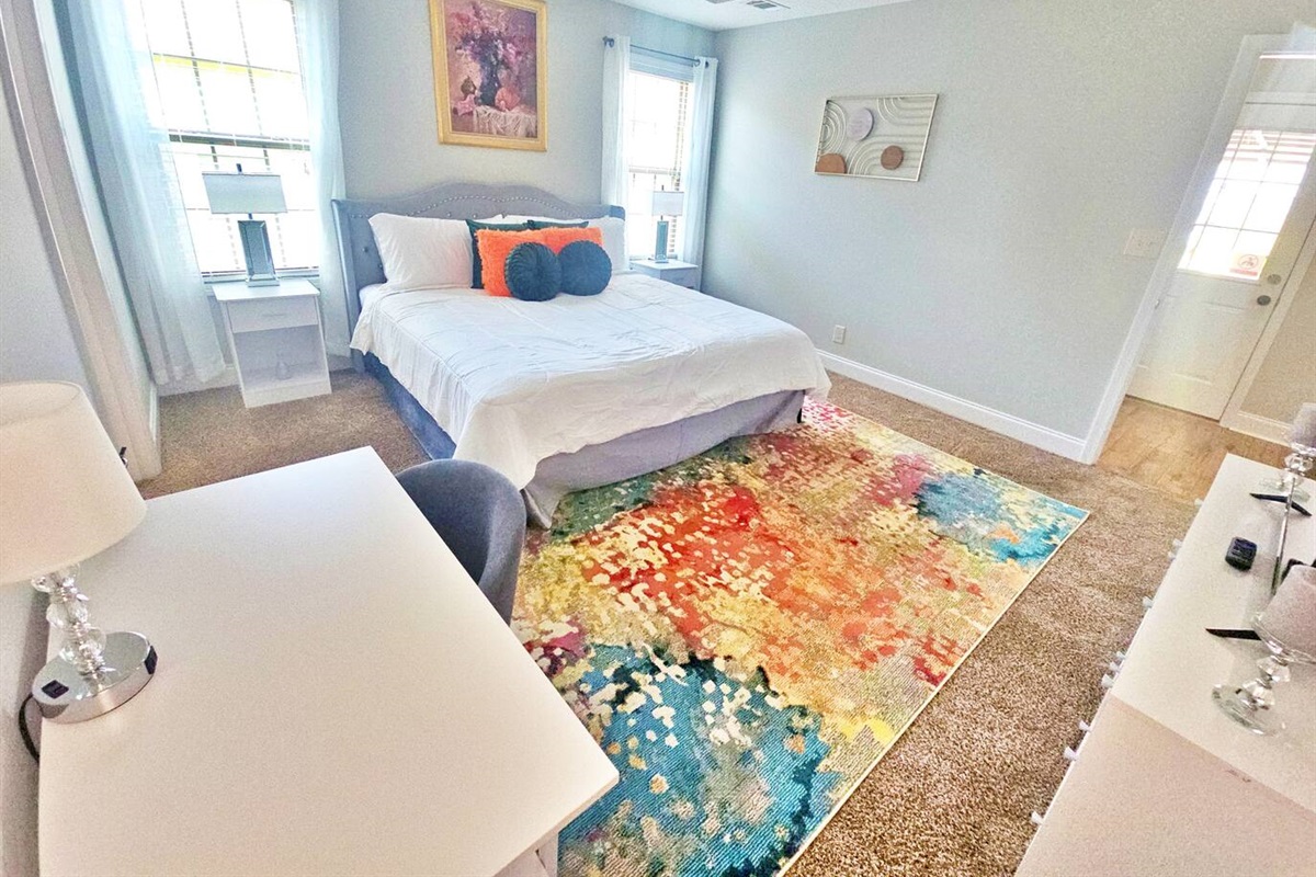 Relax in this hotel-style bedroom. There is a king bed along with a flat-screen smart TV.