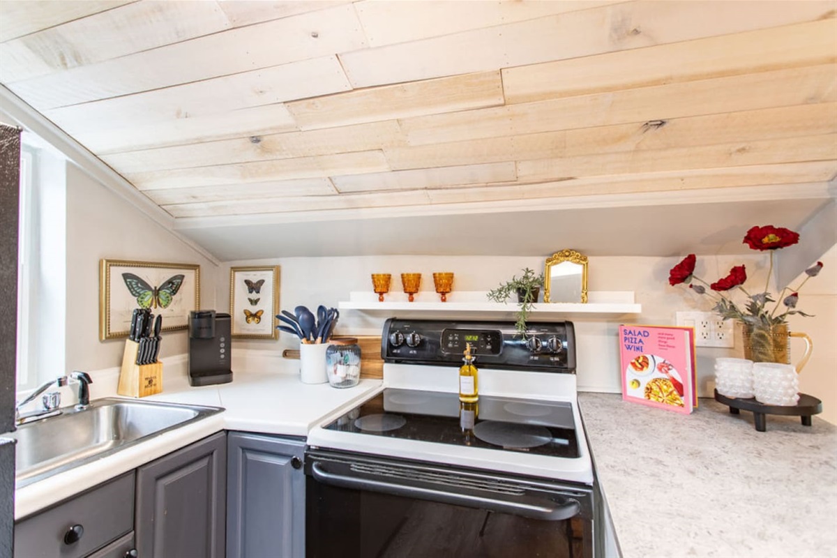 Experience the charm and efficiency of this thoughtfully designed compact kitchen. Every detail has been carefully planned to maximize space and functionality, making meal preparation a breeze. Despite its size, the kitchen feels surprisingly spaciou