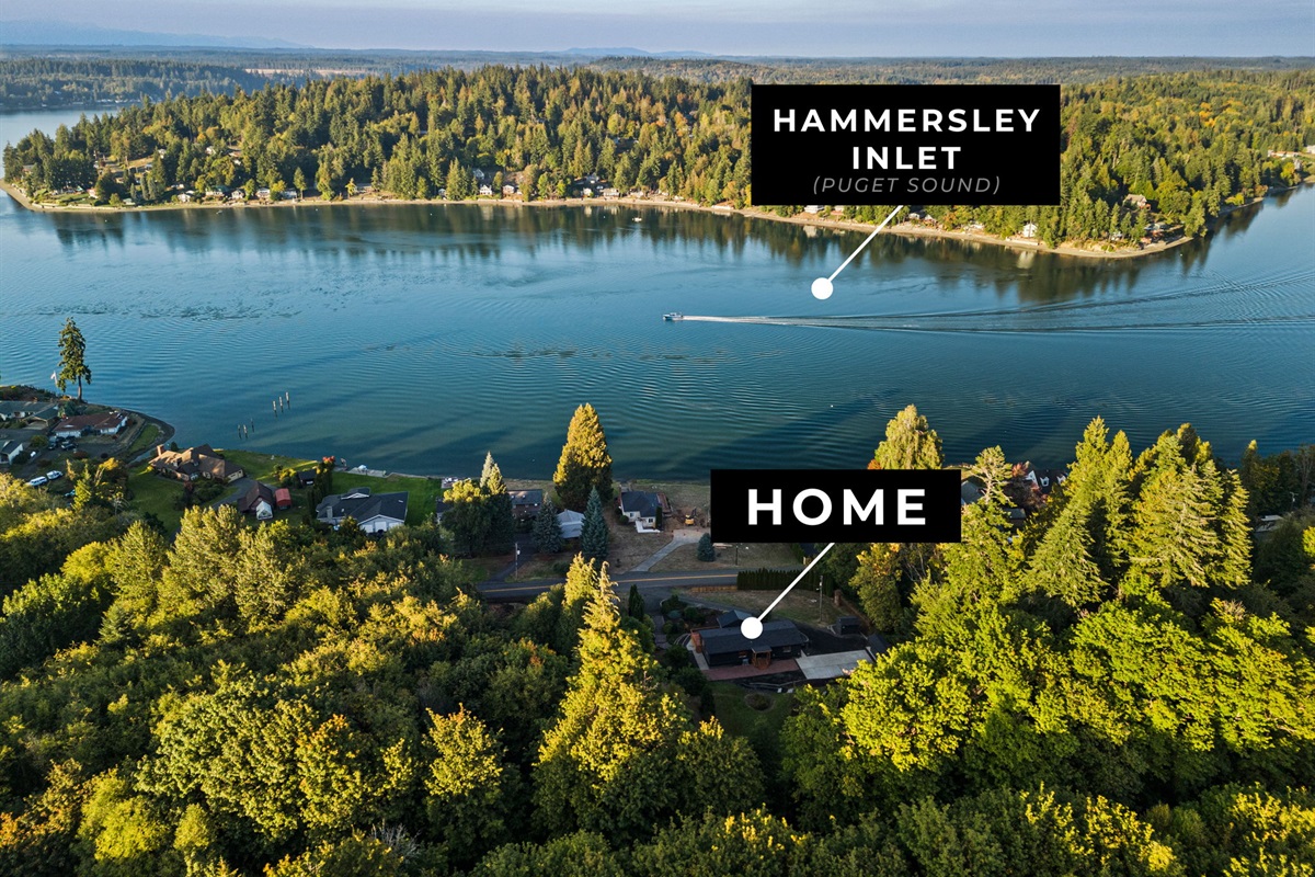 Daytime aerial showcasing the home with peaceful views of Hammersley Inlet and beyond