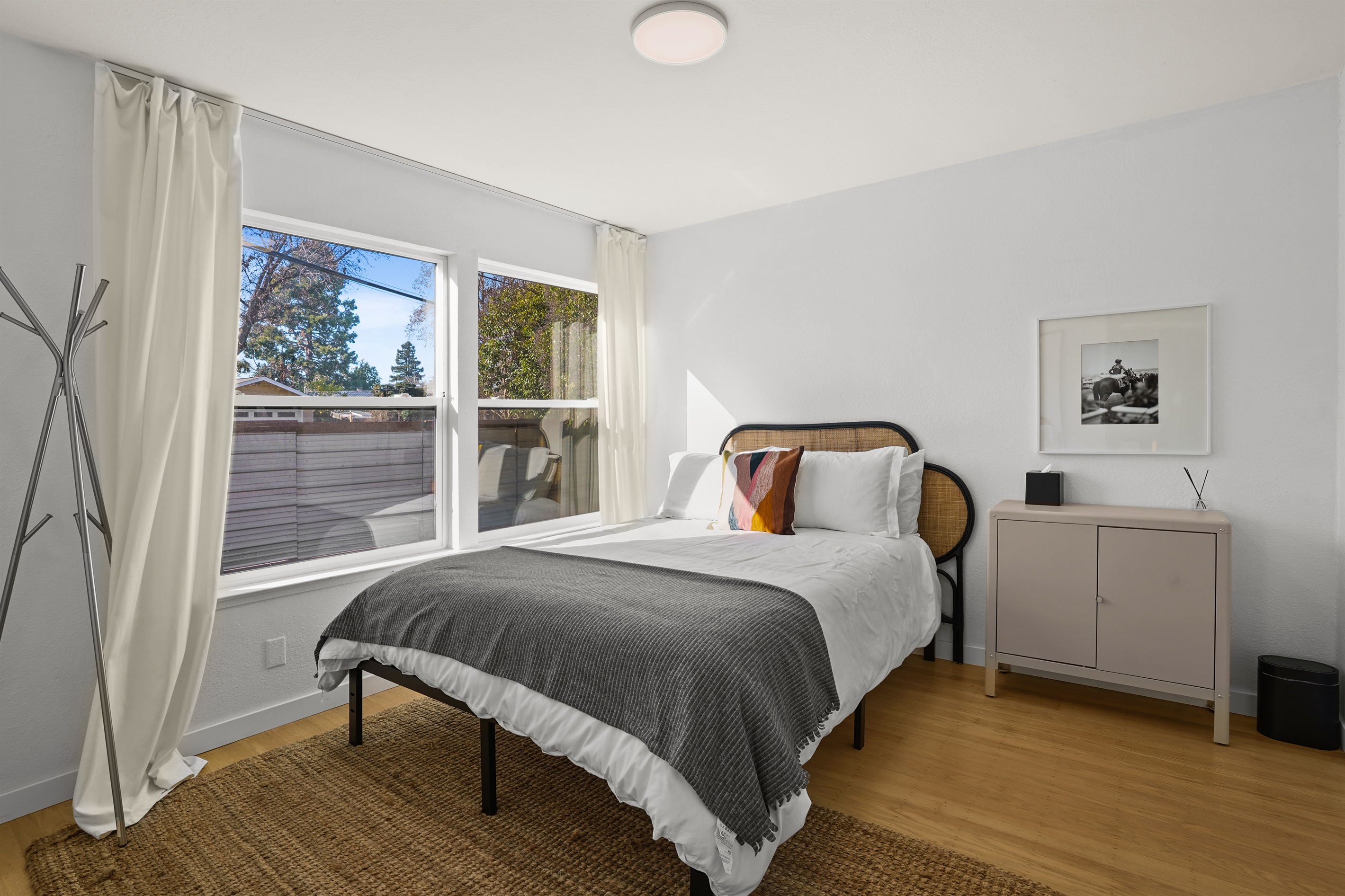 Inviting guest bedroom with a cozy queen bed, soft linens, and a peaceful atmosphere for a restful night's sleep.