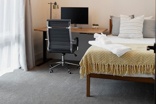 This room is on the main floor, featuring a work area and a single plush mattress bed.