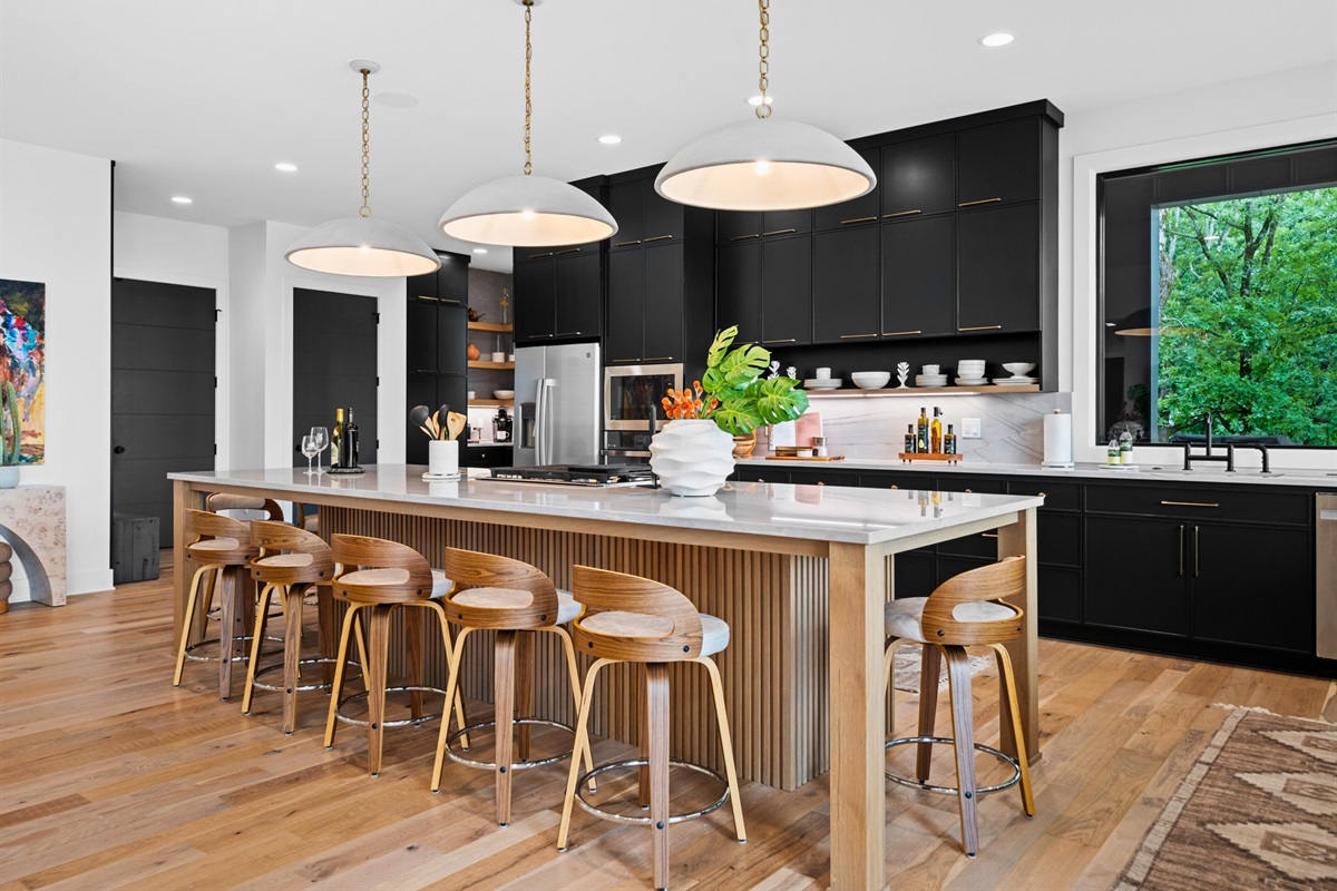 Gather around the island and enjoy the perfect blend of style and practicality in this kitchen. The modern appliances make cooking seamless.