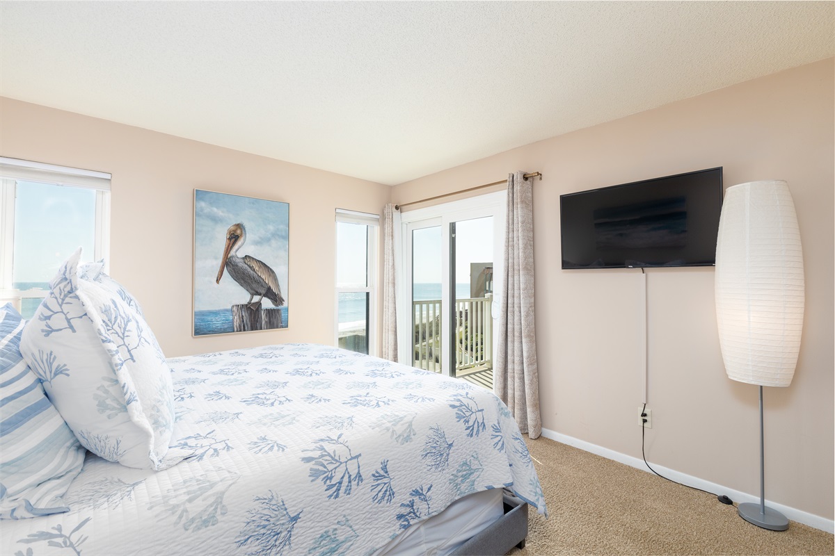 Bedroom with TV and balcony access