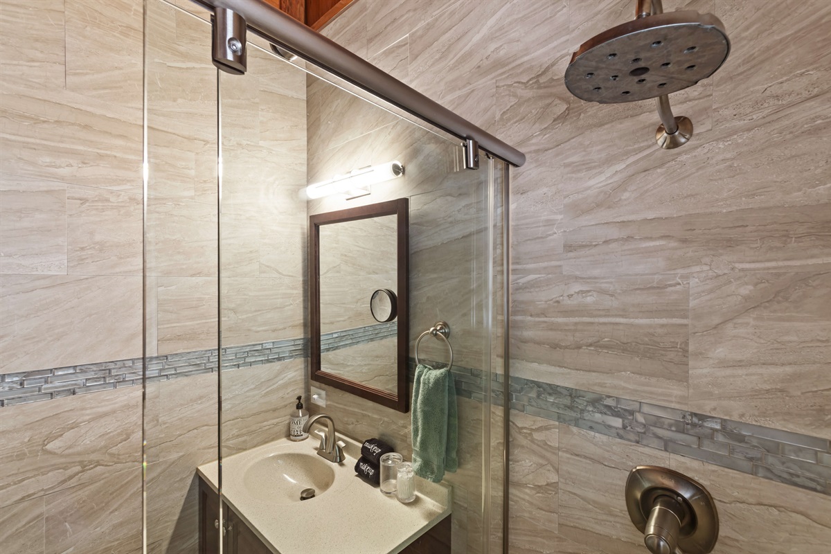 Has a modern, walk in shower.