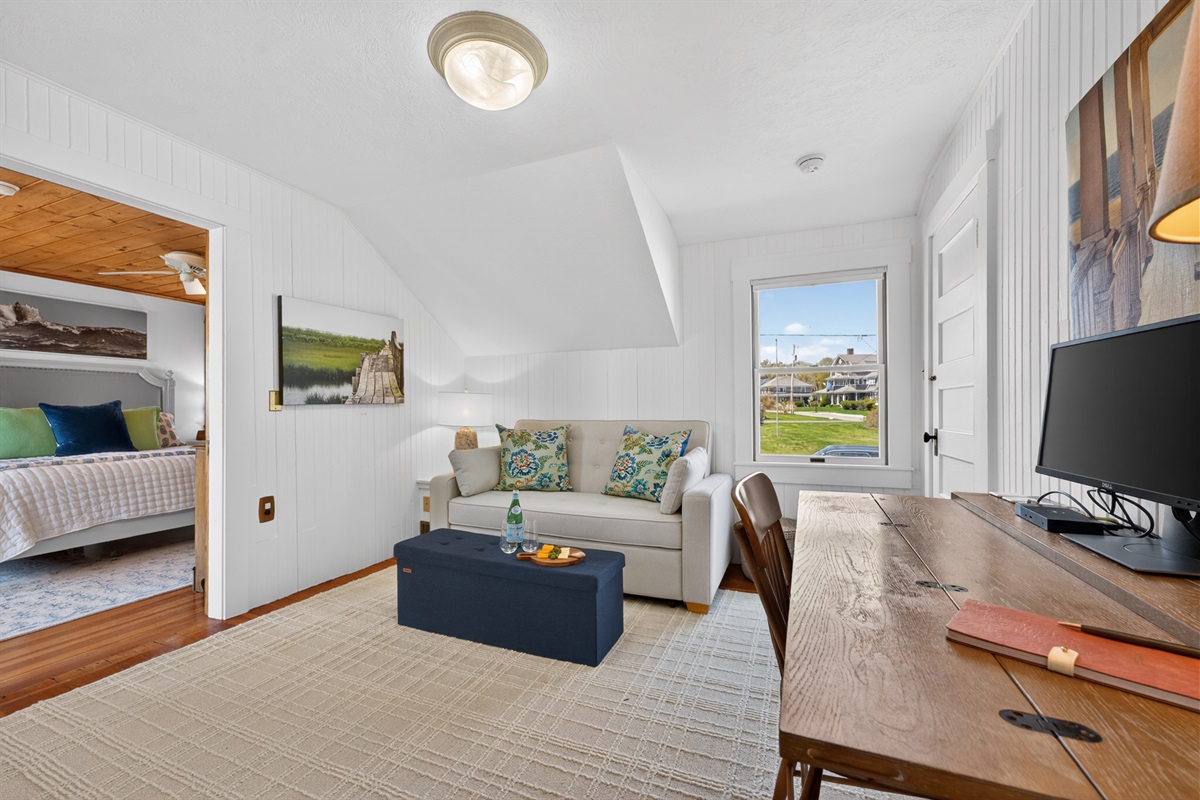 Welcome to our first upstairs bedroom! Featuring an extra pull-out sofa and a work space just for you!