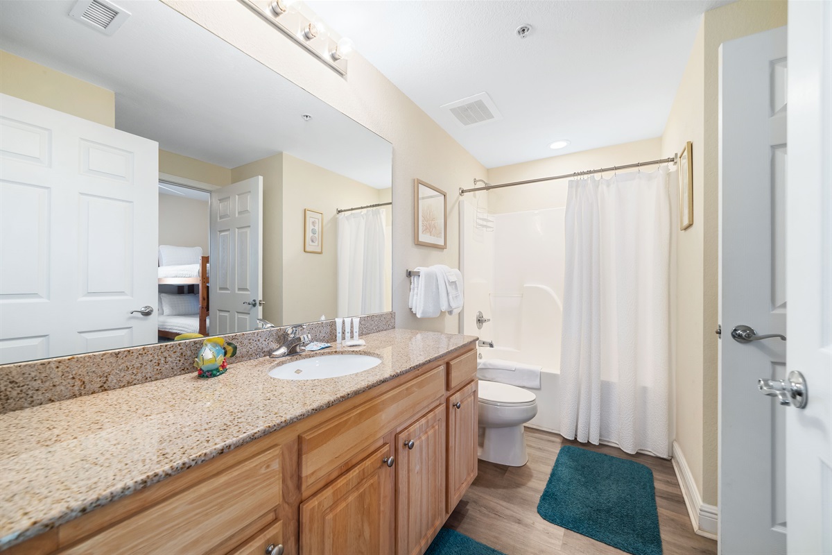 Freshly updated bathroom featuring a shower/tub combination, ample vanity space, and modern fixtures.