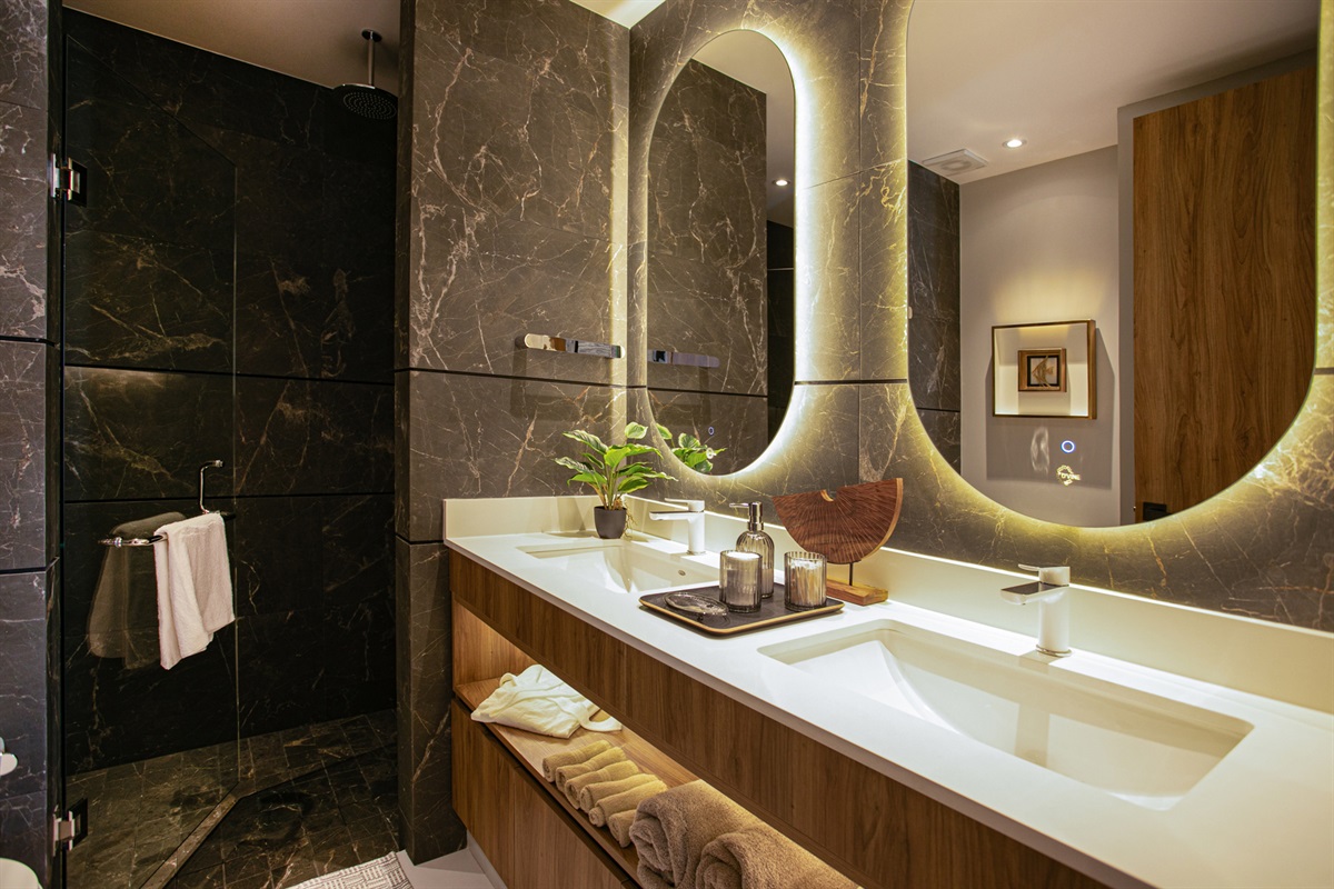 A spa-like primary bathroom featuring double sinks—perfect for couples or travelers who love extra space and convenience.