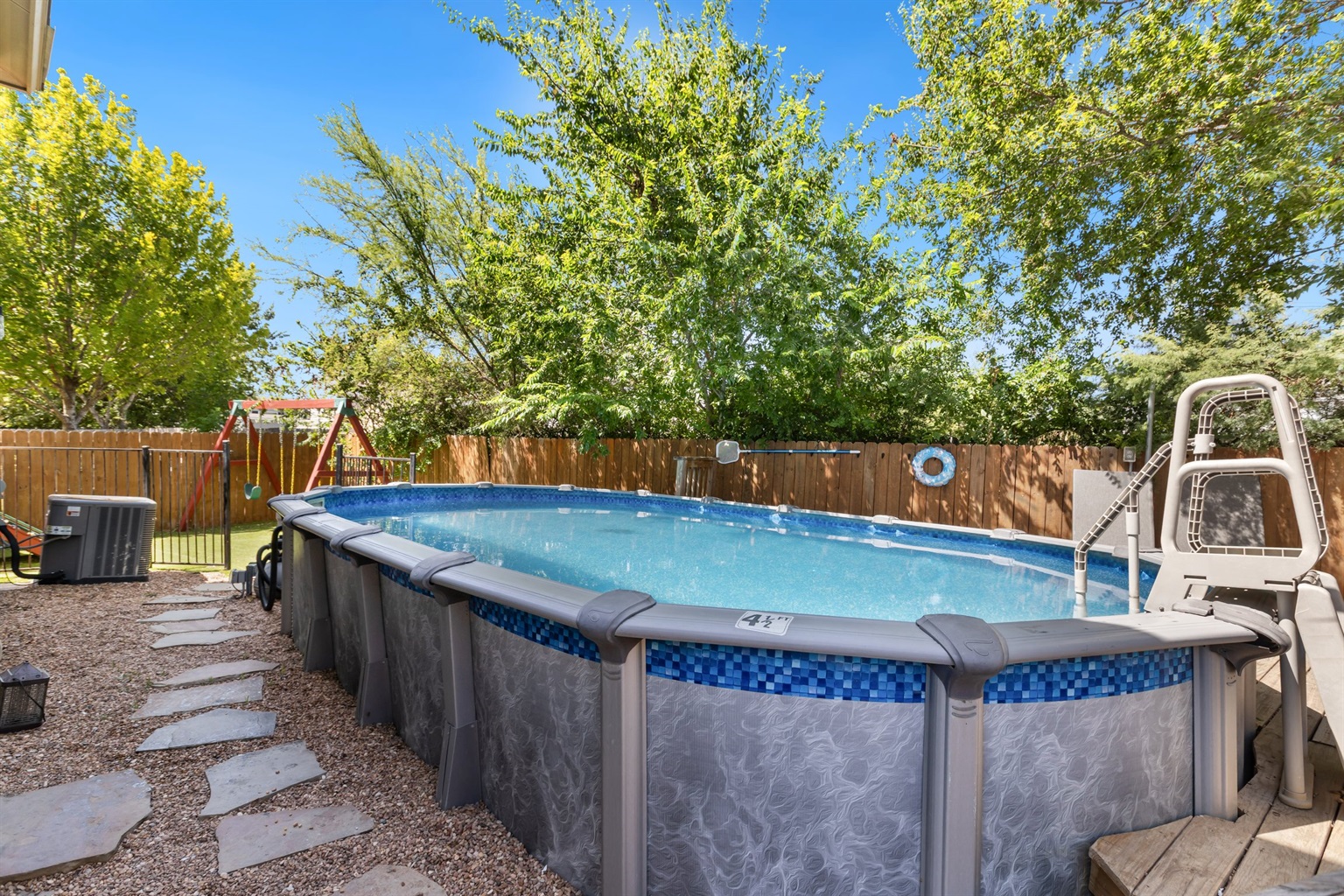Private above-ground pool with stepping stone patio in a fully fenced backyard. Crystal clear water, ladder access, and patio lounging — exclusive to your group of up to 10 in Northeast San Antonio.