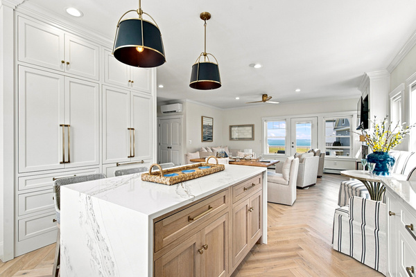 An expansive kitchen with abundant cabinetry and island seating provides plenty of room for the whole group.