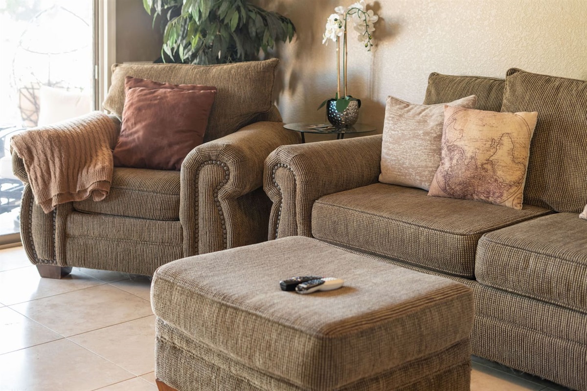 Sink into the plush, nailhead-trimmed armchair or stretch out on the sofa — the living room is designed for ultimate comfort and relaxation.