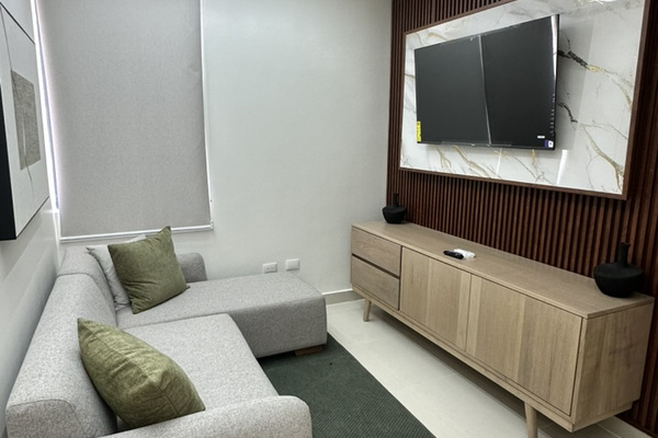 Cozy TV lounge area with a comfy sofa—perfect for movie nights, relaxing, or hooking up your own gaming console. 🎮🍿📺