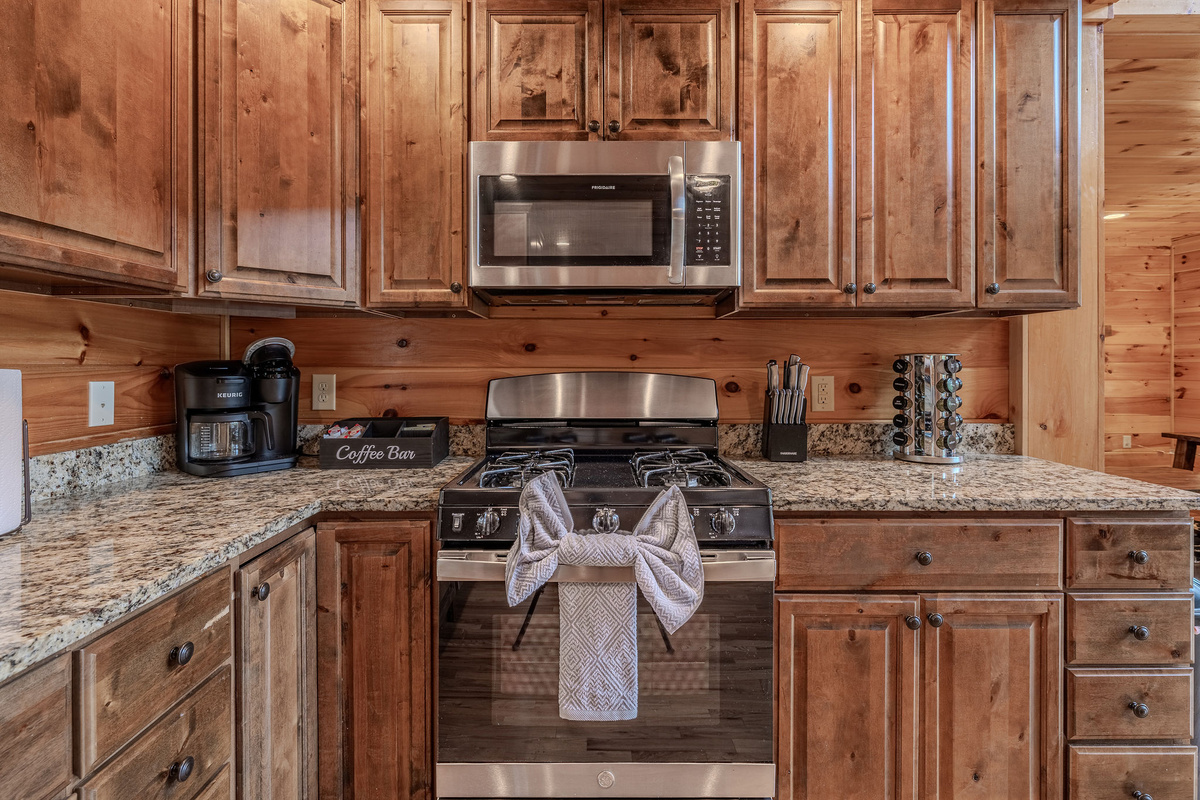 Full-size appliances, generous counters, and open sightlines make the kitchen a functional hub for the group.