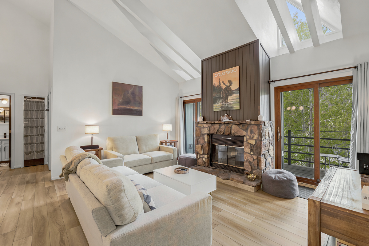 Living room with electric fireplace, 65" TV, private deck