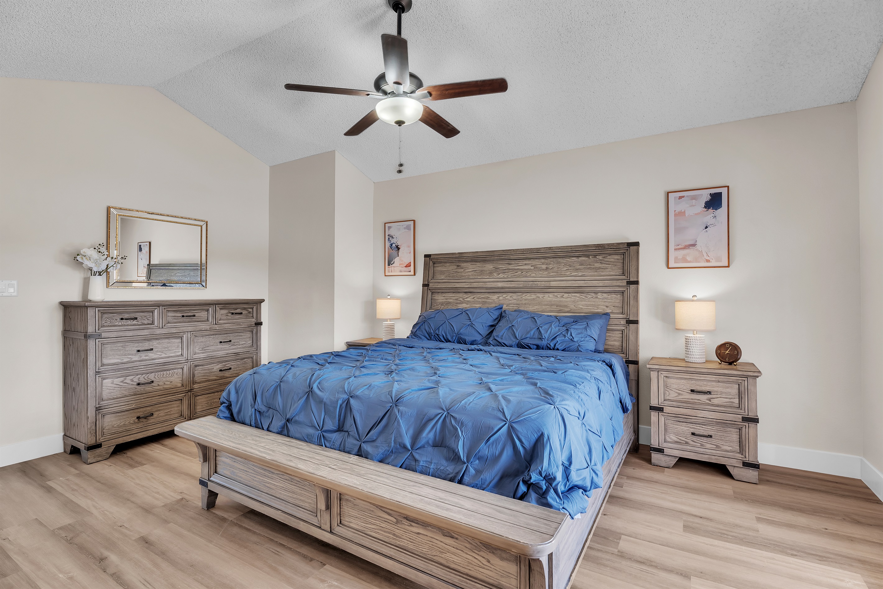 Bedroom 4 with king bed, 60 inch smart tv, walk in closet with table/chair, ensuite bathroom, and dresser