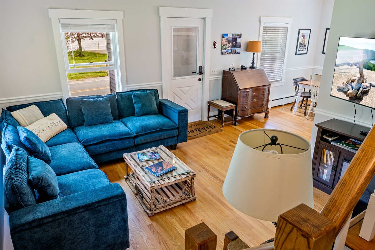 A bird’s-eye view of your 1880 retreat. This shot from the historic staircase shows the bright, open flow between our living and dining areas. A perfect Quiet Side home base for families exploring Acadia and Bar Harbor.