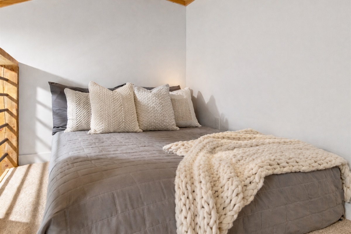 This tucked-away double bed offers a quiet and restful spot to recharge.