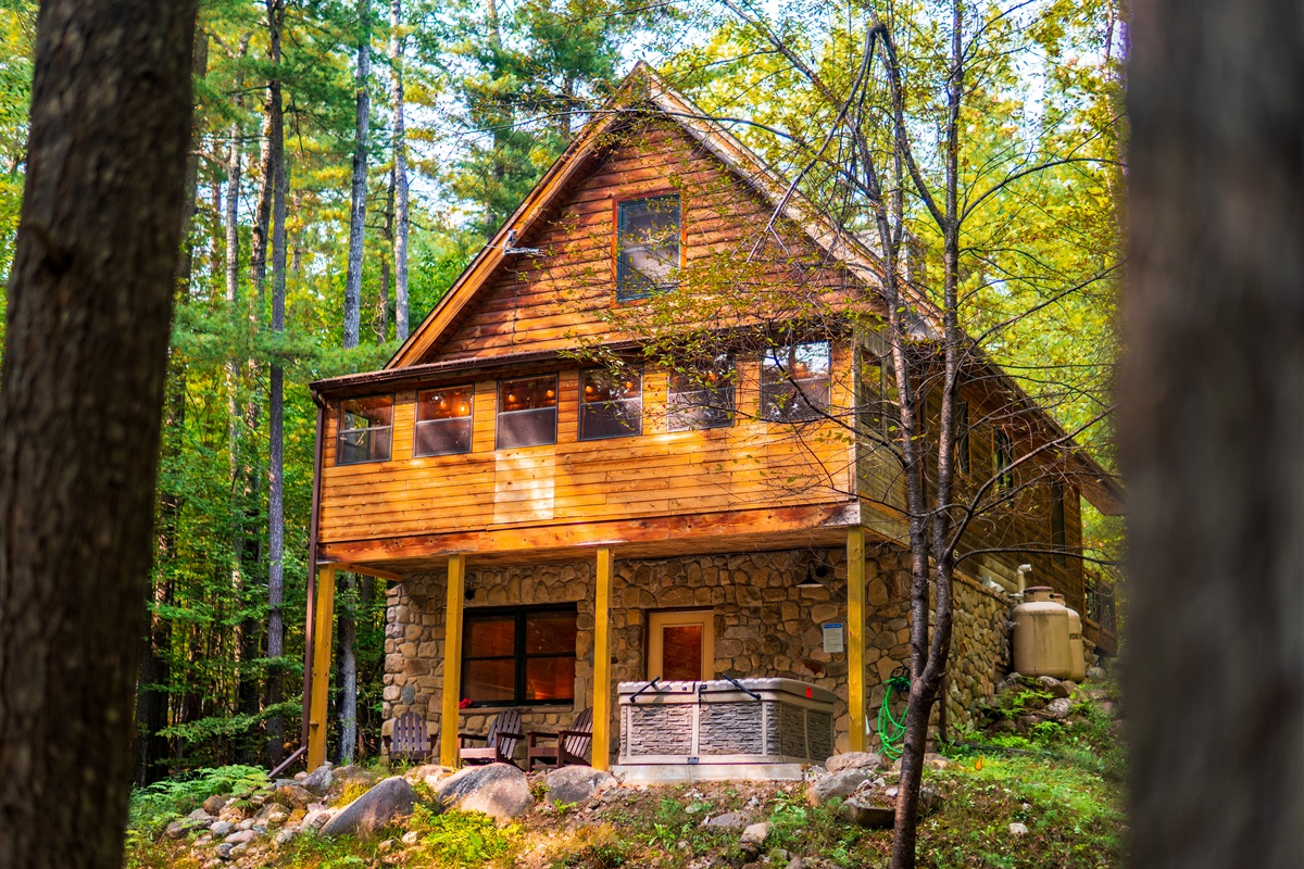 A view of the back of Adirondack Mountain Cabin, an elegant 3-bedroom home in the heart of the Adirondack Mountains. 