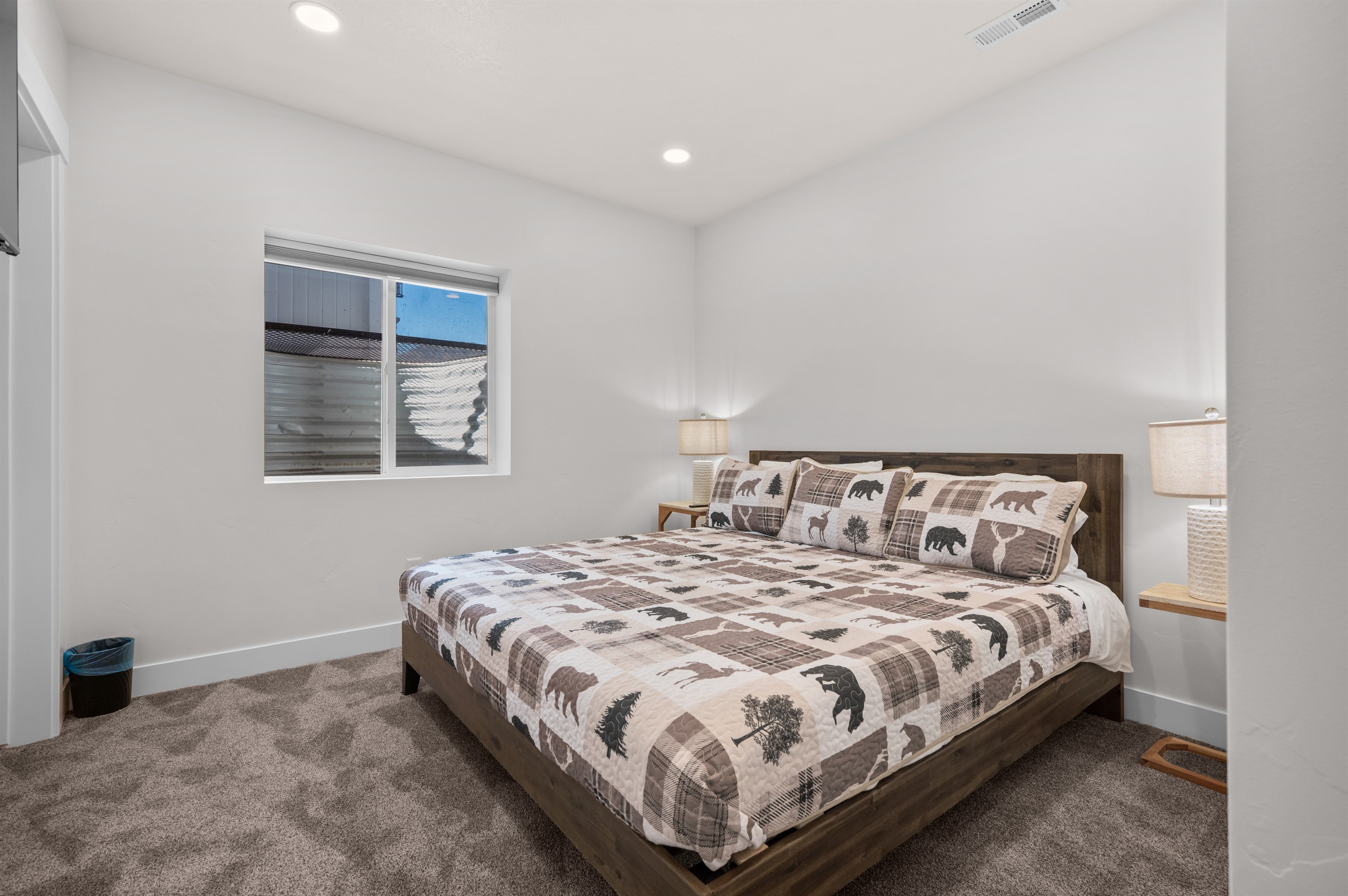 Primary bedroom with king bed, soft linens, and calming mountain tones.