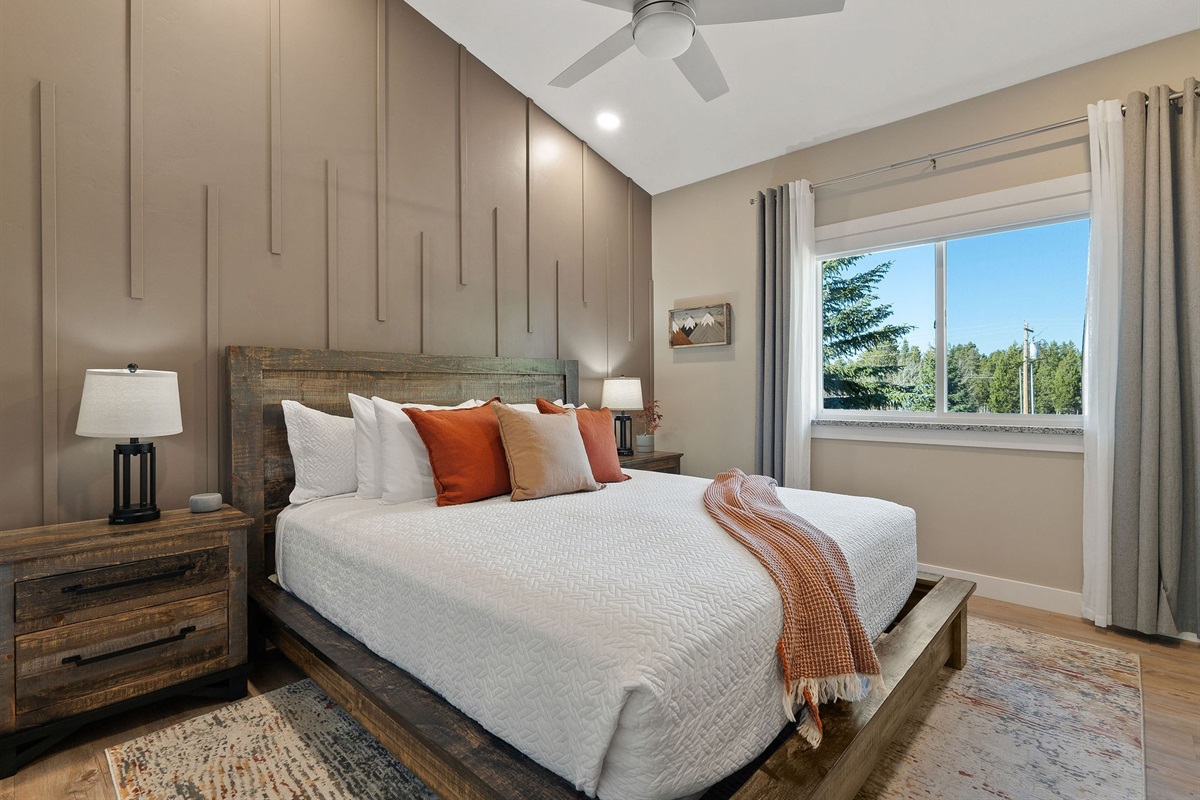 The Prismatic/Excelsior bedroom features a spacious king bed and is located across the hall from the second bathroom. Both bedrooms include sheer window coverings for daylight, along with room-darkening shades and curtains for a good night’s sleep.