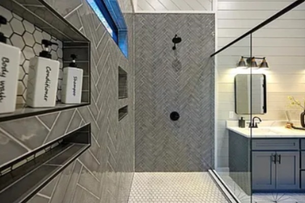 Stylish walk-in shower with premium tile work and built-in shelving.