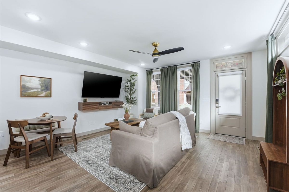 Cozy dining area with a stylish round table and seating for four, perfectly positioned next to the open-concept living space—ideal for enjoying meals, morning coffee, or casual gatherings.