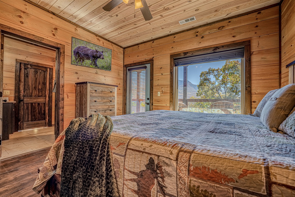 Third king bedroom with walk-out deck access and mountain views.”