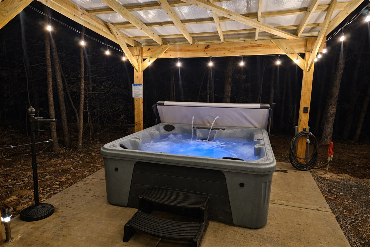 Slip into the warm, bubbling hot tub beneath a covered pavilion and soft string lights—an intimate, romantic escape designed for quiet moments and unforgettable evenings together at Eagle Retr