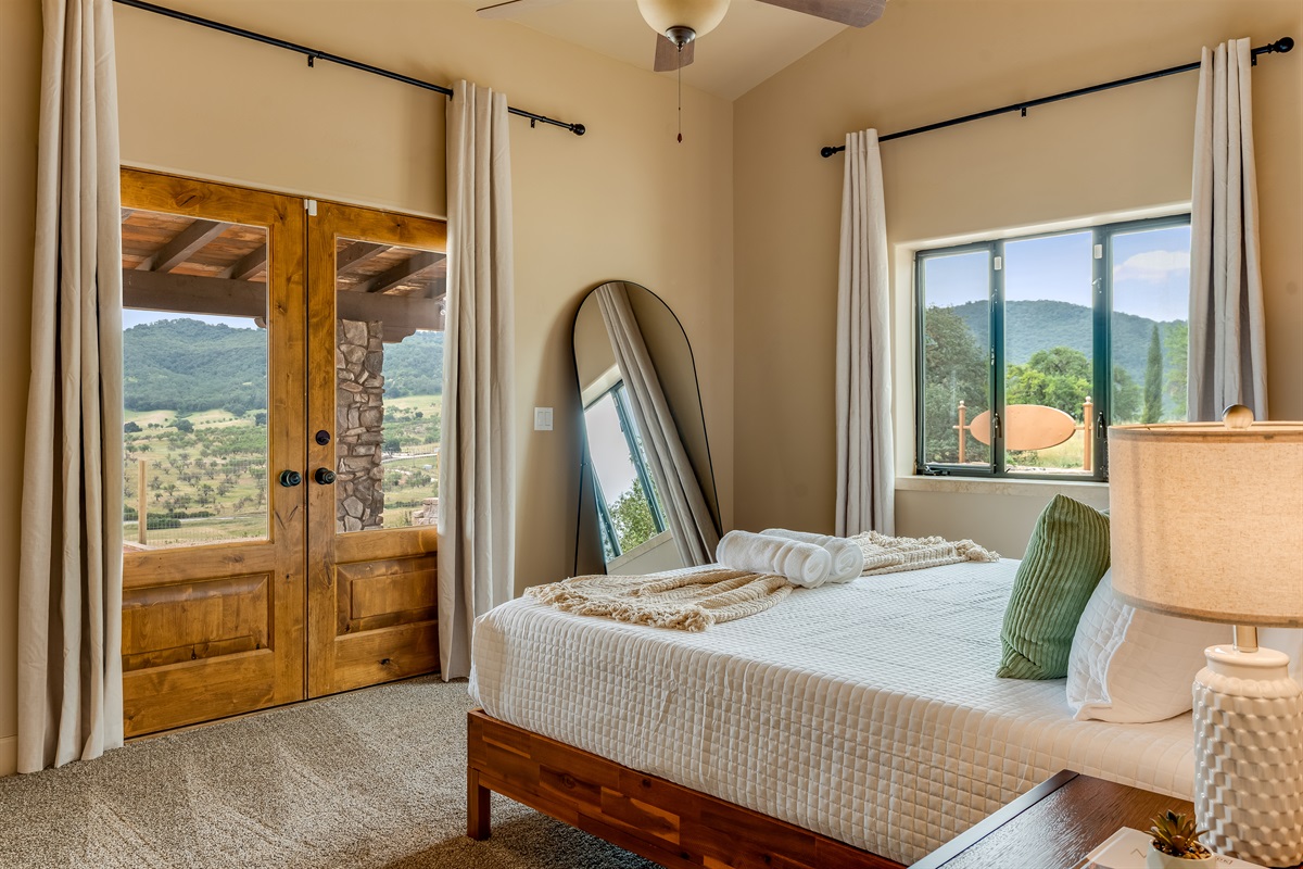 Downstairs Bedroom 1 with King sized bed and patio access
