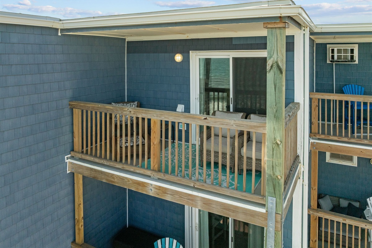 Oceanfront balcony with comfortable seating to relax and enjoy the coastal views