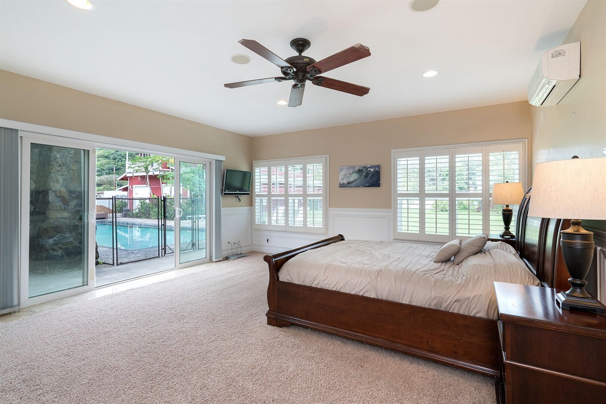 Primary bedroom #1 with ceiling fan and access to patio