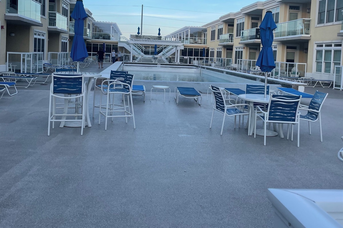 Shared rooftop space with grills, fire pits overlooking bay