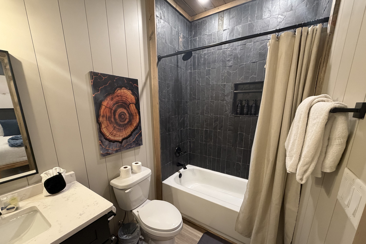 Second King en-suite bathroom downstairs with shower/tub combo