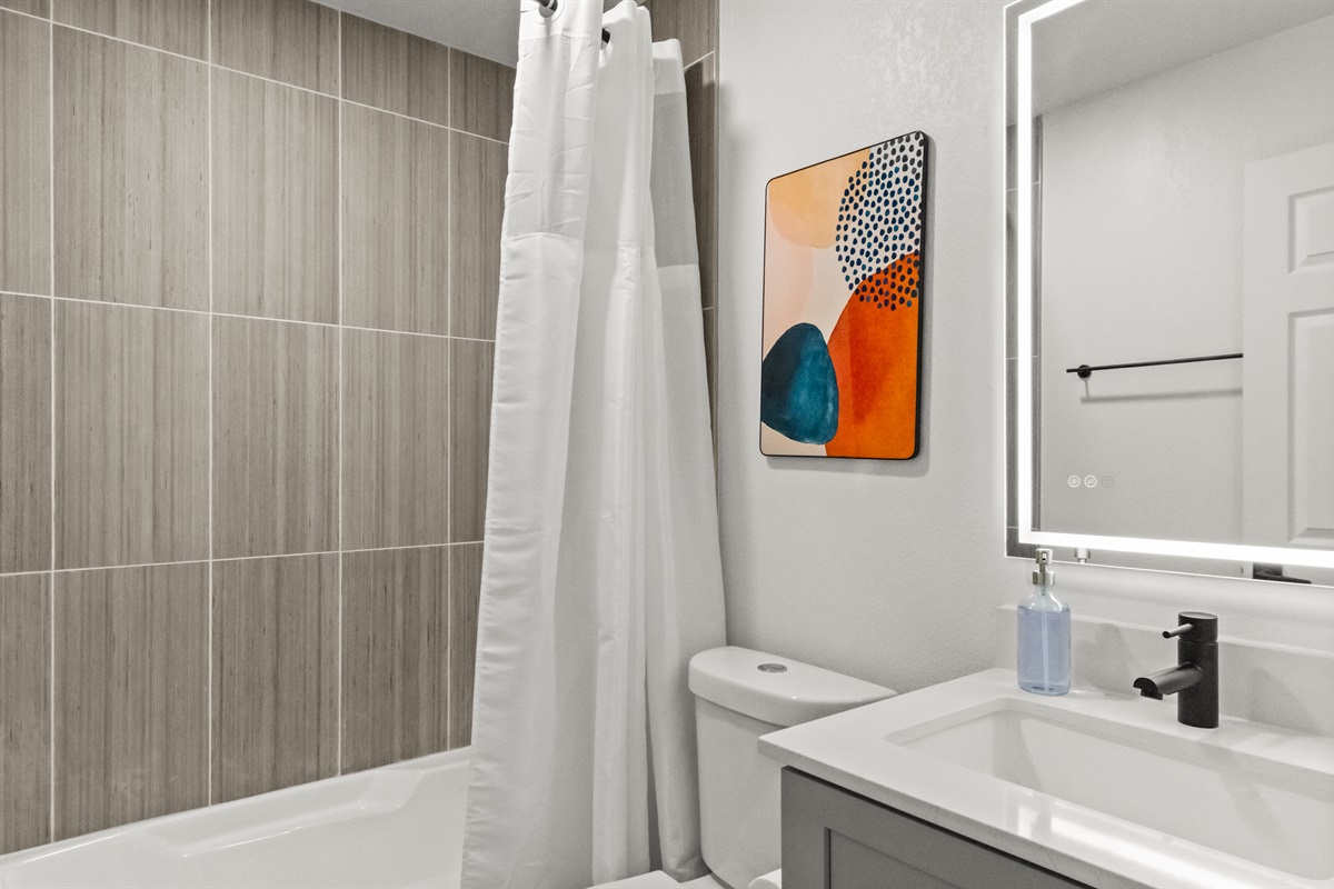 efresh in a bright and airy bathroom with ample lighting.