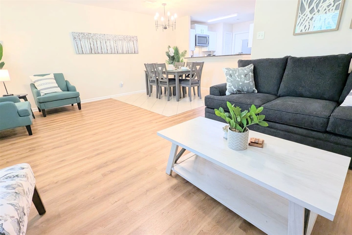 Warm and inviting open concept living, dining, and kitchen.