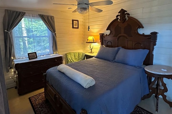 Rest easy in the main double  bedroom, complete with soft linens, blackout curtains, and charming cabin views. Quiet, private, and ideal for a good night’s sleep after a day outdoors.