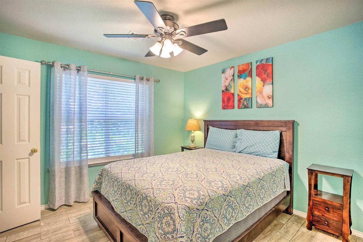 Master bedroom with queen size bed, walk in closet, and attached bathroom.